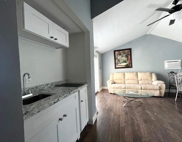 kitchen with ceiling fan, white cabinets, sink, dark hardwood / wood-style flooring, and vaulted ceiling