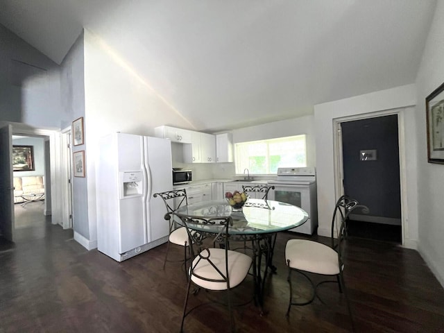 interior space featuring white cabinets, sink, white appliances, high vaulted ceiling, and dark wood-type flooring