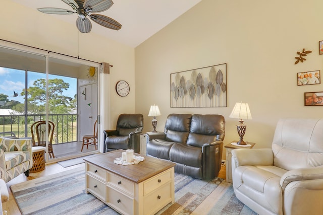 living room featuring light hardwood / wood-style flooring, high vaulted ceiling, and ceiling fan