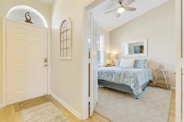 bedroom featuring light hardwood / wood-style floors, ceiling fan, and vaulted ceiling