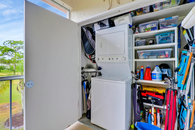 washroom with stacked washer and clothes dryer