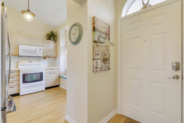 kitchen with light hardwood / wood-style floors, white appliances, lofted ceiling, and pendant lighting