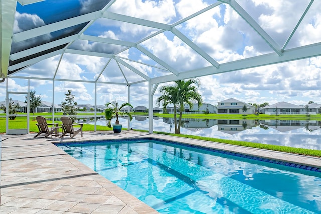 view of swimming pool featuring a water view, a patio area, and a lanai