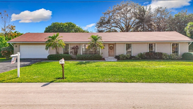 ranch-style home with a front yard and a garage