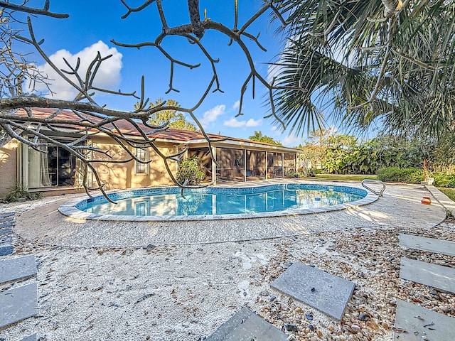 view of pool featuring a sunroom