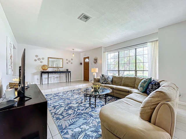 living room featuring light tile patterned floors and a textured ceiling