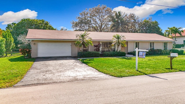 ranch-style home with a garage and a front lawn