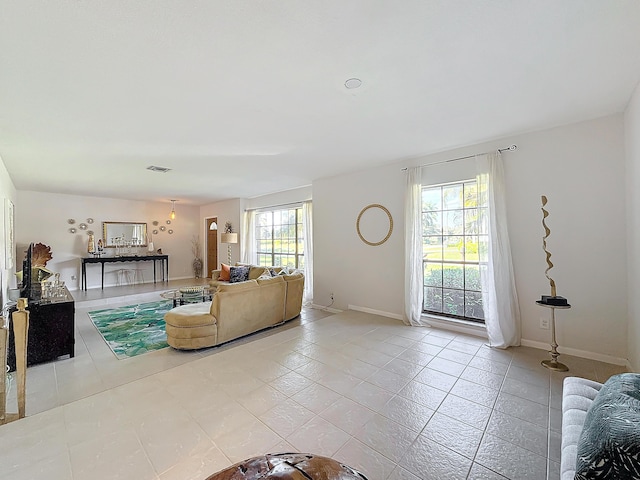 living room with a wealth of natural light and light tile patterned flooring