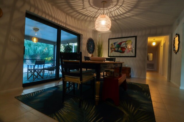 tiled dining area with an inviting chandelier