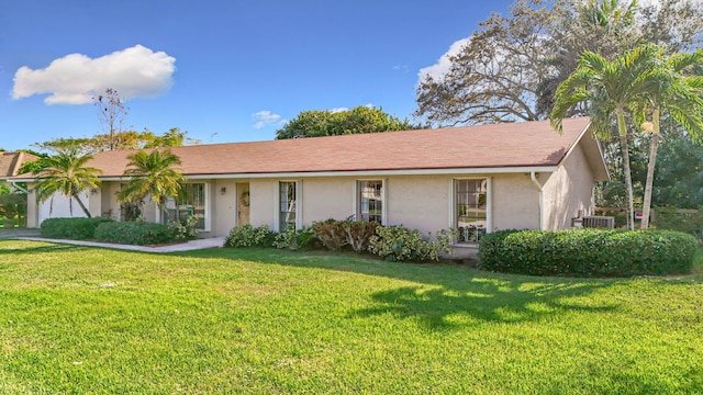 ranch-style house with a front lawn and cooling unit