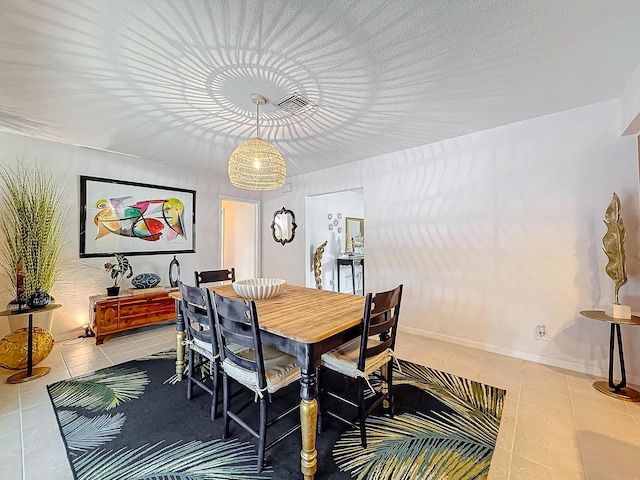 dining area featuring an inviting chandelier and light tile patterned flooring