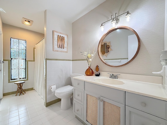 bathroom featuring a shower with shower curtain, tile patterned floors, vanity, tile walls, and toilet