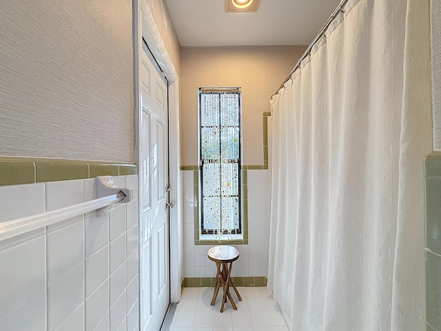 bathroom featuring tile patterned floors and tile walls