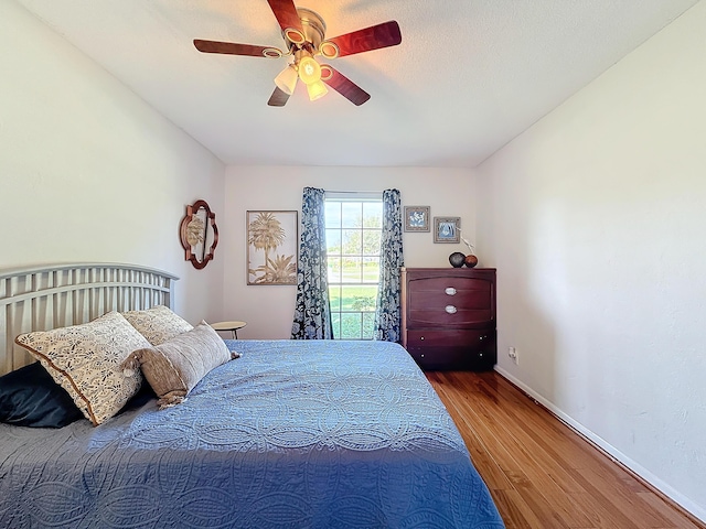 bedroom with hardwood / wood-style flooring and ceiling fan