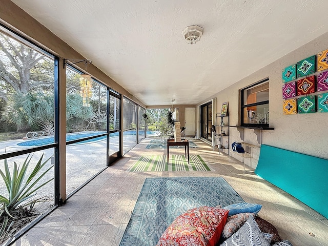 sunroom / solarium with a healthy amount of sunlight and a swimming pool