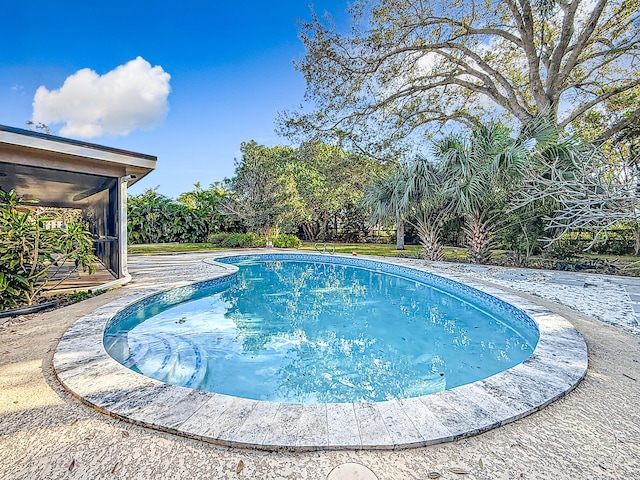 view of pool featuring a sunroom