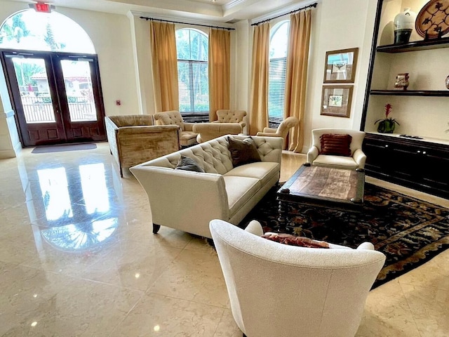 living room with light tile patterned floors, ornamental molding, and french doors