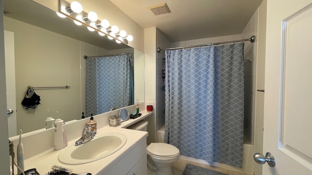 bathroom with vanity, toilet, and tile patterned floors