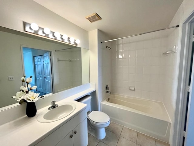 full bathroom featuring tile patterned flooring, vanity, toilet, and tiled shower / bath