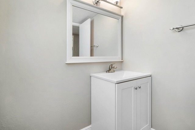 bathroom with a textured ceiling and oversized vanity