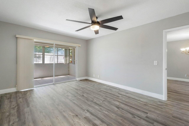 spare room with ceiling fan, a textured ceiling, and light wood-type flooring