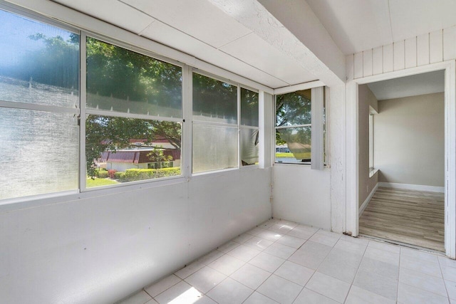 unfurnished sunroom featuring a wealth of natural light