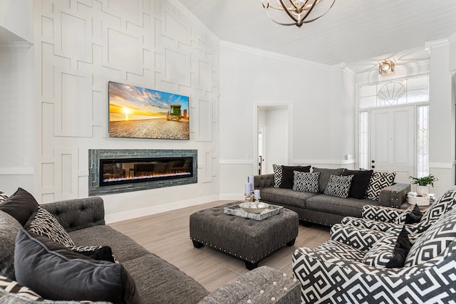 living room with crown molding and light hardwood / wood-style floors