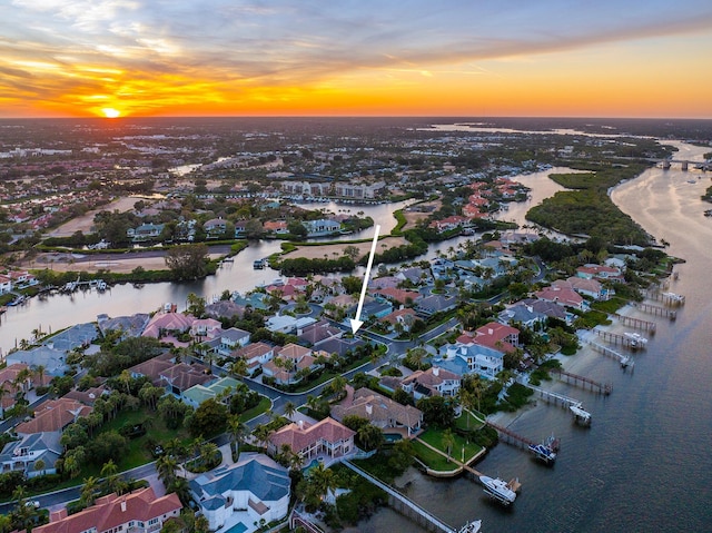 aerial view at dusk with a water view