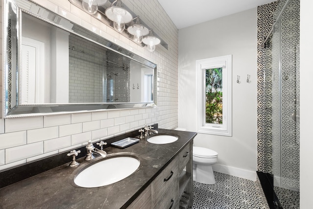 bathroom with tile flooring, vanity with extensive cabinet space, tile walls, dual sinks, and toilet