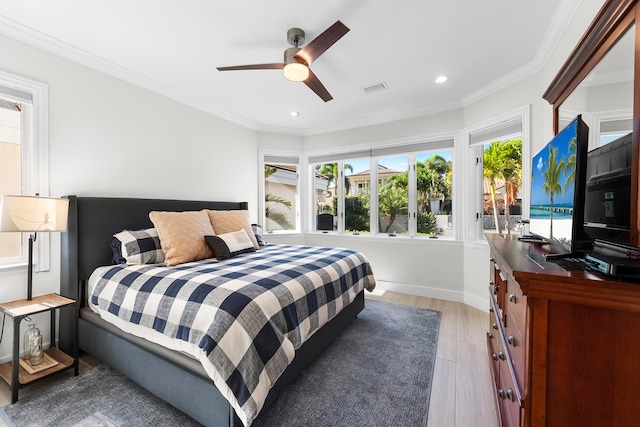 bedroom with ceiling fan, light wood-type flooring, and ornamental molding