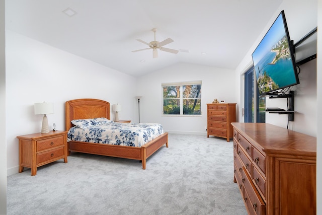 bedroom with vaulted ceiling, light colored carpet, and ceiling fan