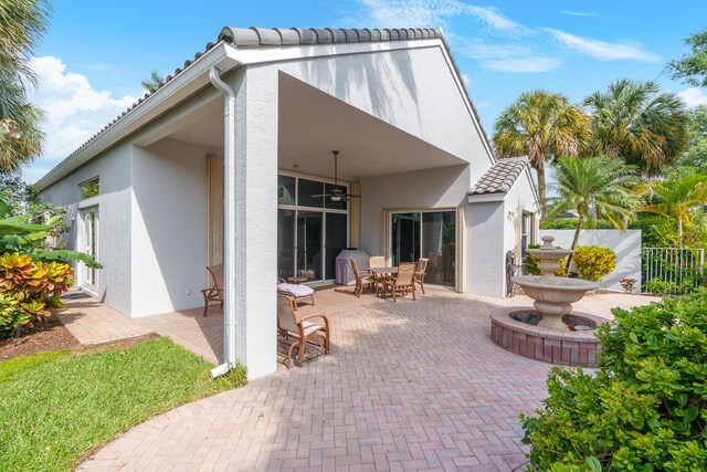 back of property with a patio and ceiling fan