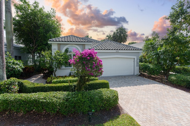 mediterranean / spanish house featuring a garage