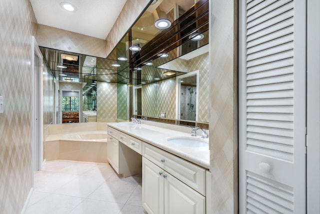 bathroom featuring a bath to relax in, tile flooring, and dual vanity