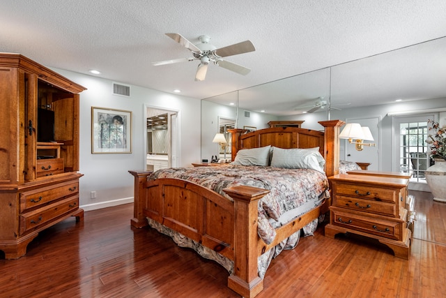 bedroom featuring dark hardwood / wood-style flooring, ceiling fan, and a textured ceiling