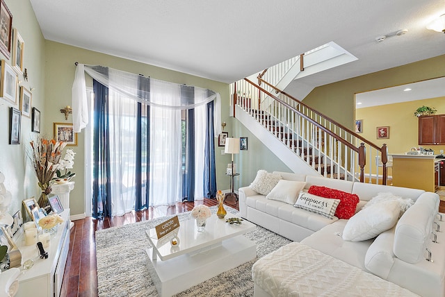 living room with dark hardwood / wood-style flooring and plenty of natural light