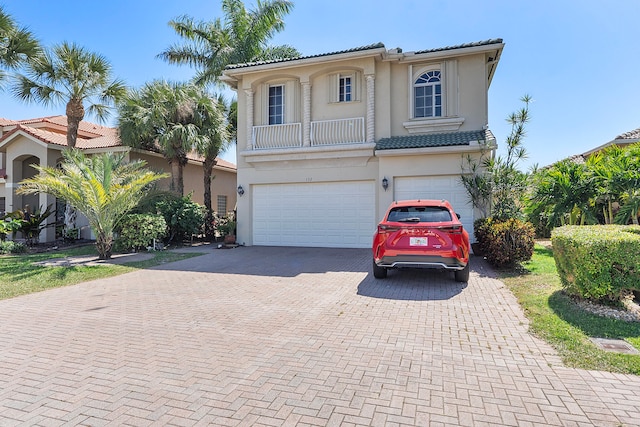 mediterranean / spanish home with a garage