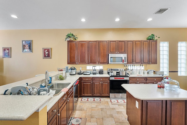 kitchen with sink, appliances with stainless steel finishes, and light tile flooring