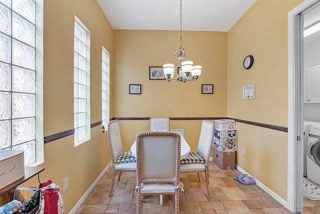 dining space featuring a chandelier, light tile floors, and washer / dryer