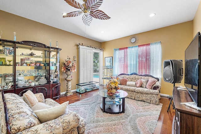 living room with hardwood / wood-style floors and ceiling fan