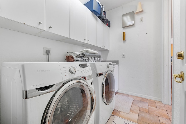 laundry area with hookup for an electric dryer, cabinets, washer and dryer, and light tile floors