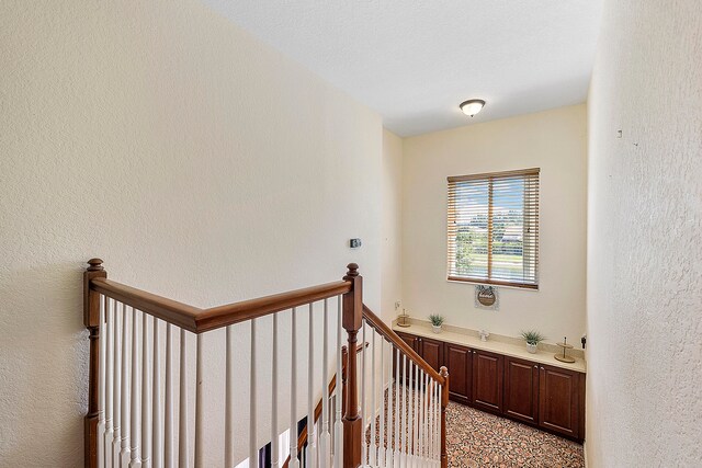 stairs featuring light colored carpet