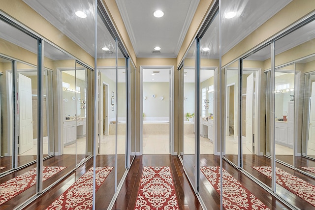 corridor with dark hardwood / wood-style flooring and crown molding