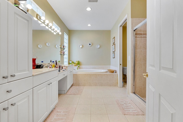 bathroom with vanity, tile floors, and plus walk in shower