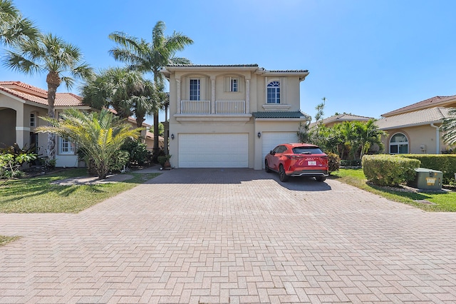 mediterranean / spanish house with a garage and central AC