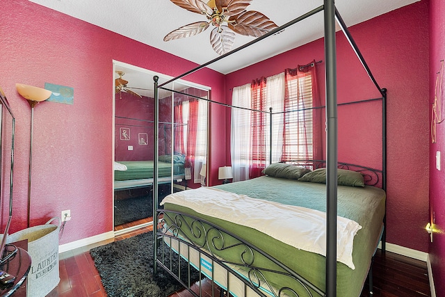 bedroom with dark hardwood / wood-style flooring and ceiling fan