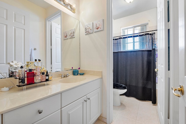 bathroom featuring tile floors, vanity, and toilet