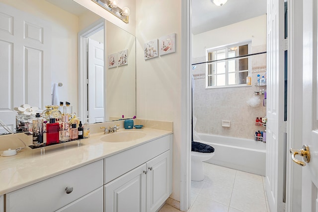 full bathroom with tiled shower / bath combo, toilet, tile floors, and vanity