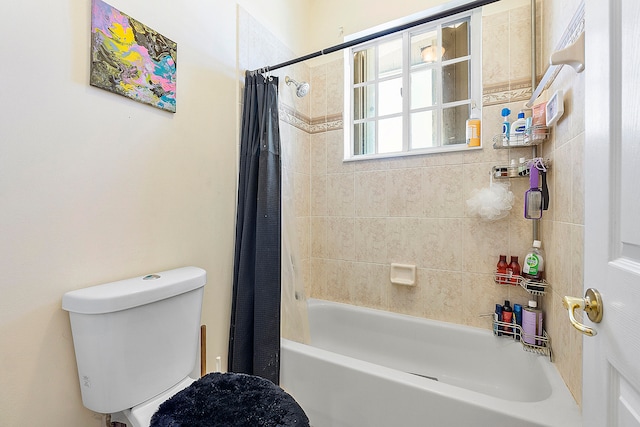 bathroom with shower / bath combination with curtain and toilet