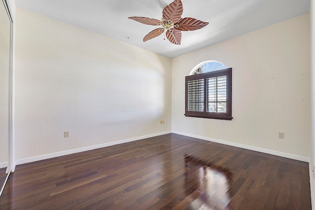 unfurnished room featuring ceiling fan and dark hardwood / wood-style flooring